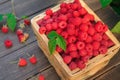 Red fresh raspberries basket on brown rustic wood background Royalty Free Stock Photo