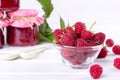 Red fresh raspberries in a glass bowl with green leaves Royalty Free Stock Photo