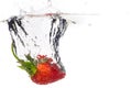 Red fresh strawberries thrown into the water, under water. Spat and splash Royalty Free Stock Photo