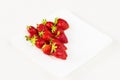 Red fresh strawberries in a white dish isolated on white background. Close up view. Royalty Free Stock Photo