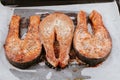 Red fried fish steaks. Baked salmon pieces. Juicy appetizing salmon lies on baking sheet. Healthy food concept Royalty Free Stock Photo