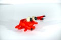 A red frog made of plasticine. Plasticine toys on white background