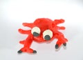 A red frog made of plasticine. Plasticine toys on white background