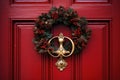 Red front door with Christmas wreath and street festive decorations on holidays Royalty Free Stock Photo