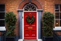 Red front door with Christmas wreath and street festive decorations on holidays Royalty Free Stock Photo