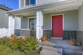 Red front door of a home with porch and stairs Royalty Free Stock Photo