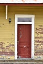 Red front door of old house with front porch Royalty Free Stock Photo