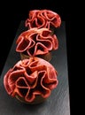 Red fruit apple and cherry leather ruffled dessert tarts on black background Royalty Free Stock Photo