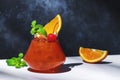 Red fruit cocktail drink with rum, pineapple juice, ssrop, orange, mint, cocktail cherry and ice. Gray and white background, hard Royalty Free Stock Photo