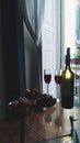 Red fruit plates, bottle and glass of red wine Royalty Free Stock Photo