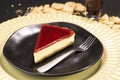 Red fruits Cheesecake frutas on a black plate Royalty Free Stock Photo