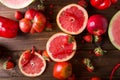 Red fruits and vegetables on a wooden background.