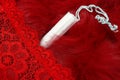 Red fur, red pants and a menstrual tampon. Vaginal products for intimate care. Woman critical days, gynecological menstruation cyc