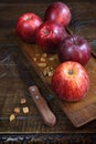 Red Gala apples on an old wooden surface