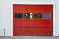 Red garage door with windows and handles