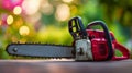Red garden chainsaw with sharp blade resting on a surface with colorful blurred natural background in soft evening light Royalty Free Stock Photo