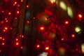 Red garlands in interior. Lights in dark. Room details. Light on window Royalty Free Stock Photo