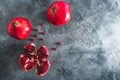 Red garnet fruits on dark background. Food background. Flat lay, top view
