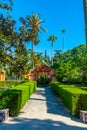 Red gate at gardens of Real Alcazar de Sevilla in Spain Royalty Free Stock Photo