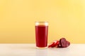 Red Gemuse vegetable drink in tall glass. Vegan Smoothie Juice of radishes, purple carrots, beets, turnips and other vegetables Royalty Free Stock Photo