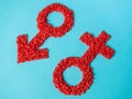 Red gender symbols of small hearts on a blue background. Male and female sign composed of hearts Royalty Free Stock Photo