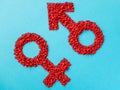 Red gender symbols of small hearts on a blue background. Male and female sign composed of hearts Royalty Free Stock Photo