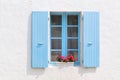 Red Geraniums with blue blinds Royalty Free Stock Photo