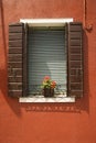 Red geraniums on window sill.