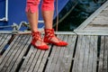 Red Ghillies with womans feet on a mooring at lake constance