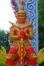 Red giant statue standing at the entrance of Ang Hin Temple, Cha-am in Thailand.