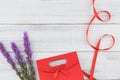 Red gift bag decorated with violet liatris flowers