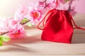 Red Gift Bag and plum blossom on Old Shabby Wooden Table concept Christmas and Newyear. Royalty Free Stock Photo