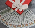 Red gift box with banter and lots of money, gift for a woman, gift with money