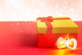 Red gift box with a bow and a heart with a glowing lamp inside on a red background with gold glitter, copyspace. Universal holiday