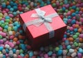 Red gift box on colorful corn chips