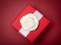 Red gift box on dark red Royalty Free Stock Photo