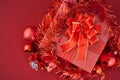 Red Gift box with decorations and color ball on red background Royalty Free Stock Photo