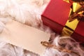 Red gift box detail with tag on feathers top wiew Royalty Free Stock Photo