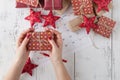 Red gift box in female hands. Christmas background