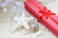 Red gift box, glittery white star and cristmas tree decorations