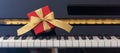 Red gift box on piano keyboard, front view Royalty Free Stock Photo