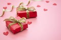 Red gift box and golden bow, on pink background. Valentine's Day, Birthday, Party concept Royalty Free Stock Photo