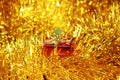 Red gift box on golden fluffy decorations