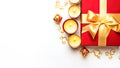 Red gift box with golden ribbon, chocolate sweets and candles on white background