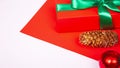 Red gift box with green ribbon and bow on colored background. copy space. Happy Christmas, New year Royalty Free Stock Photo