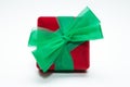 Red gift box with green ribbon  on a white background Royalty Free Stock Photo