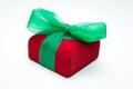 Red gift box with green ribbon  on a white background Royalty Free Stock Photo