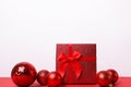 Red gift box with ribbon and balls on white background, greeting card with copy space Royalty Free Stock Photo