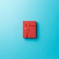 Red gift box with red ribbon on blue background. Top view. Flat lay. Copy space. Colorful background Royalty Free Stock Photo