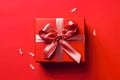 Red gift box with ribbon and bow isolated on red background.Holiday gift with Birthday, Christmas present, flat lay, top view, Royalty Free Stock Photo